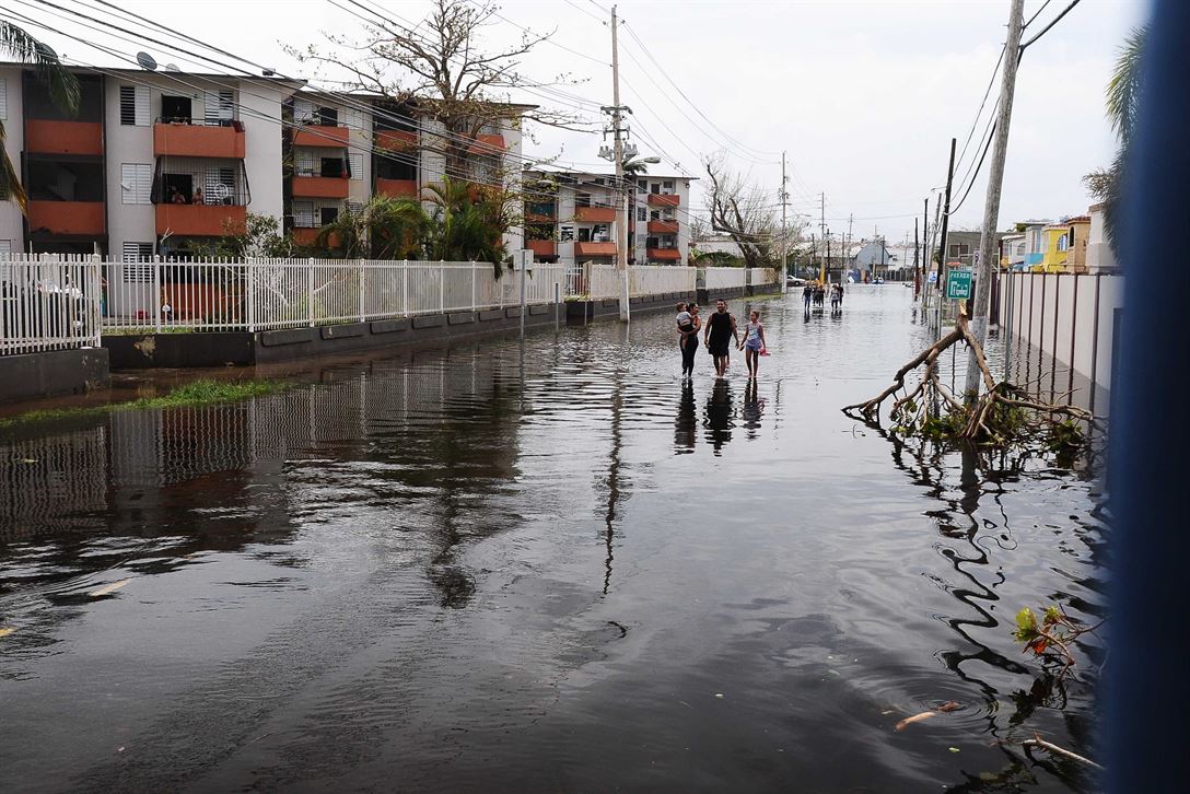 People walking in flood waters in Condado, San Juan, Puerto Rico, Sept. 22, 2017.